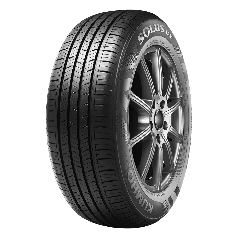 A Kumho Solus TA31 tire with a detailed tread pattern, mounted on a metal alloy wheel rim, showing sidewall branding.
