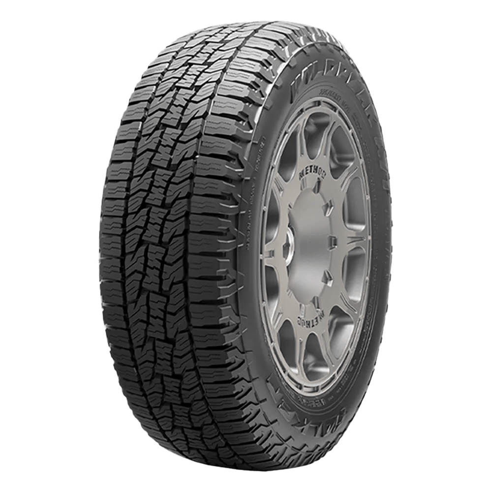 A rugged off-road tire with deep tread patterns, mounted on a metallic alloy wheel rim.