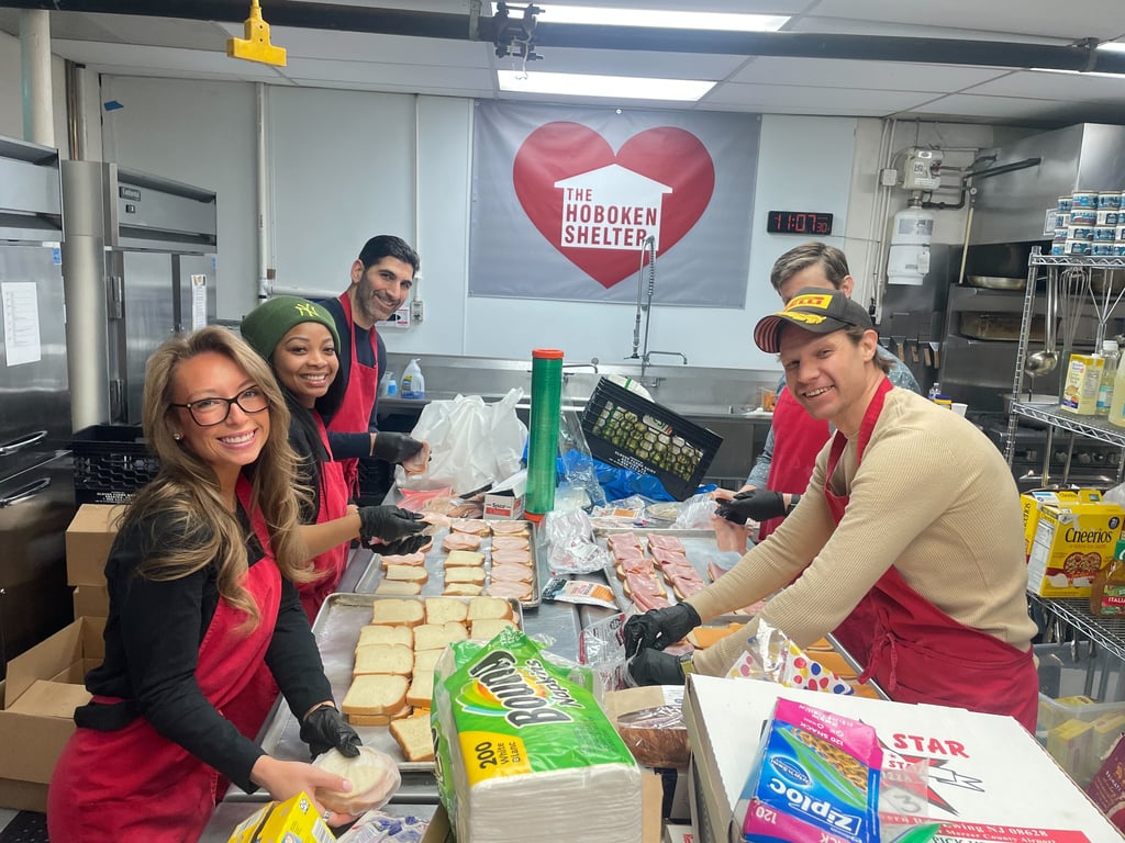Five Tire Agent team members work in the Hoboken Shelter's food kitchen