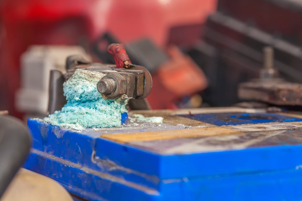 Close-up of a car battery terminal with blue corrosion buildup.