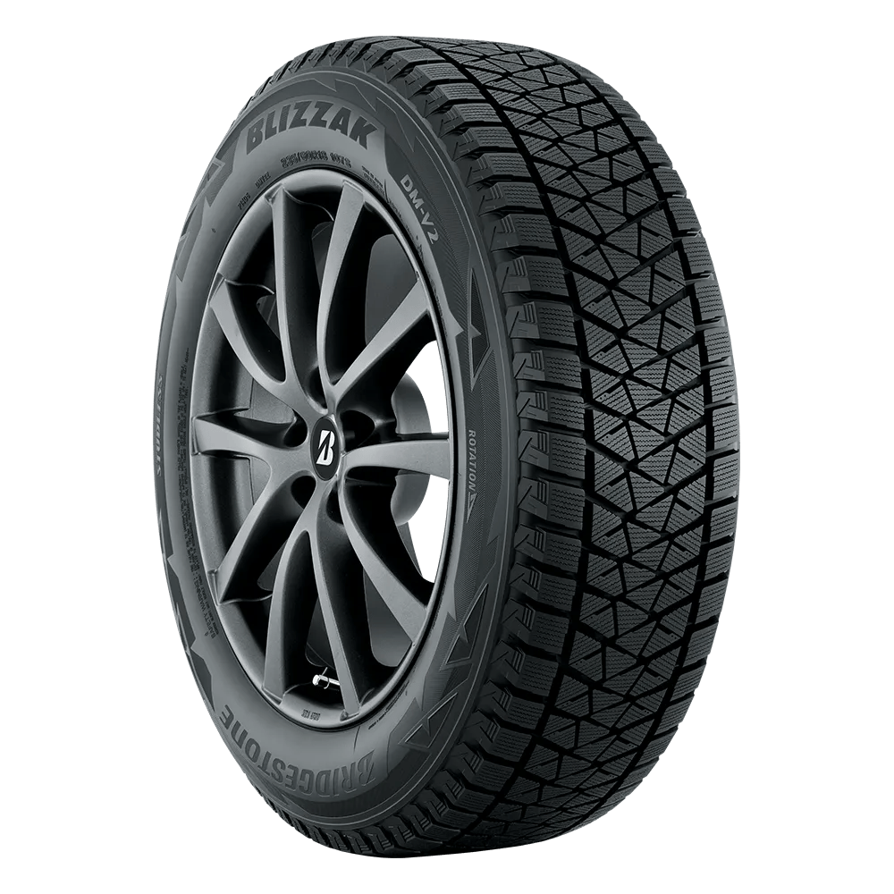 A Bridgestone Blizzak DM V2 tire from the left front side on five double-spoked rims.