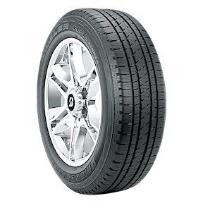 A car tire with a detailed tread pattern is mounted on a shiny alloy wheel against a plain background.