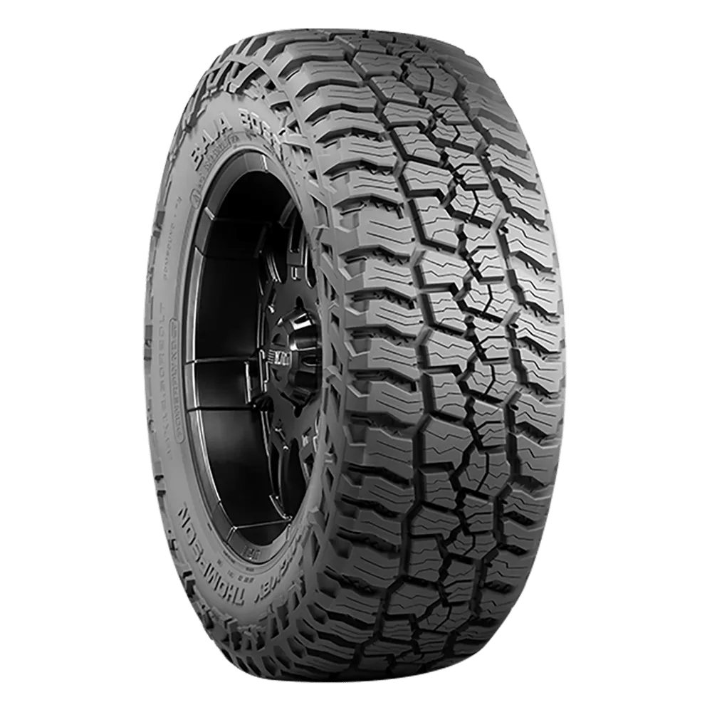 A left front side view of a Mickey Thompson Baja Boss A/T tire for an F150 tire mounted on a nonspecific black coated wheel.