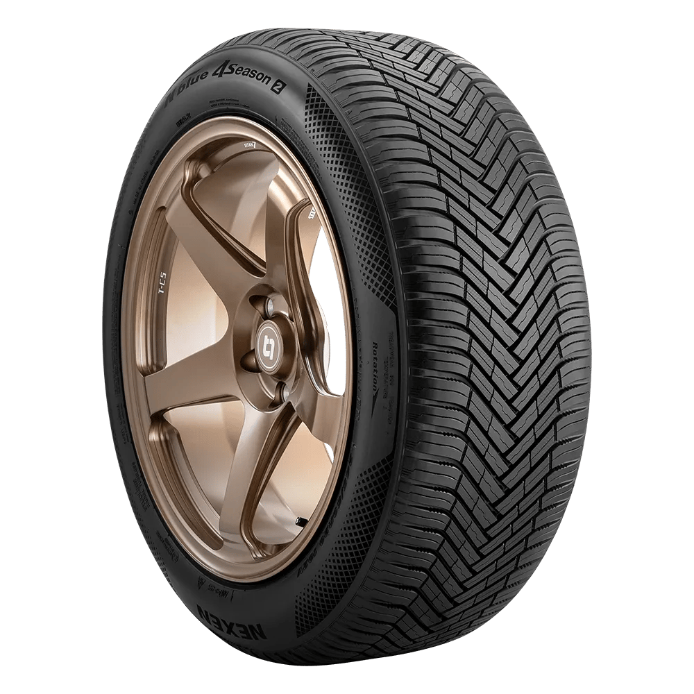 A car tire affixed to a bronze-colored alloy wheel with a detailed tread pattern, labeled as a Nexen tire suitable for all seasons.