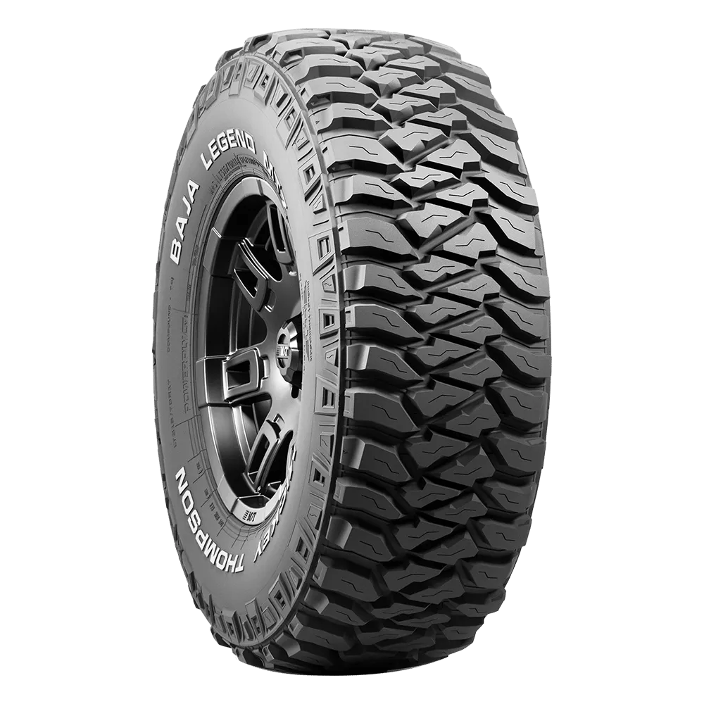 A rugged off-road tire with deep tread patterns and the words 'Baja Legend' and 'Mickey Thompson' inscribed on the sidewall.