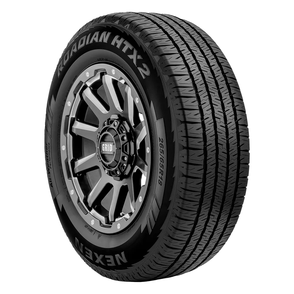 A Nexen Roadian HTX 2 tire with a detailed tread pattern and a metallic alloy wheel rim.