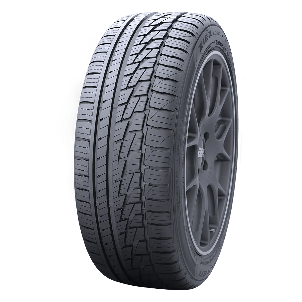 A detailed view of a black car tire with a modern tread pattern, featuring the brand name 'Ziex ZE950' visible on the sidewall.