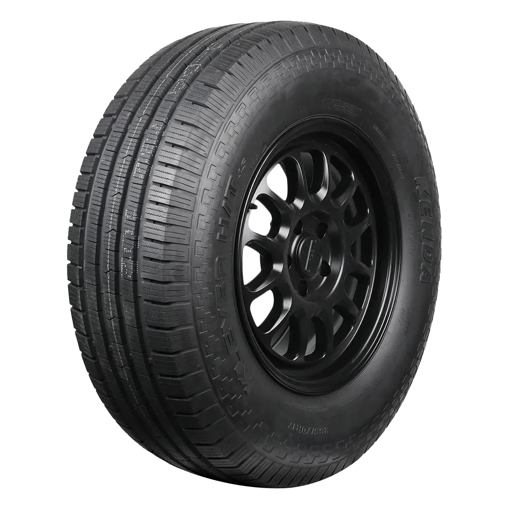 A Kenda Klever HT black car tire with visible tread patterns, mounted on a black alloy wheel.