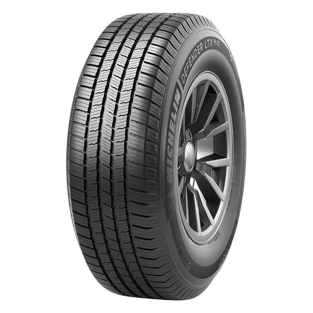 Michelin Defender LTX M/S tire with detailed tread pattern and visible sidewall branding.